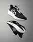 Black and white running shoes with a geometric design on a gray background