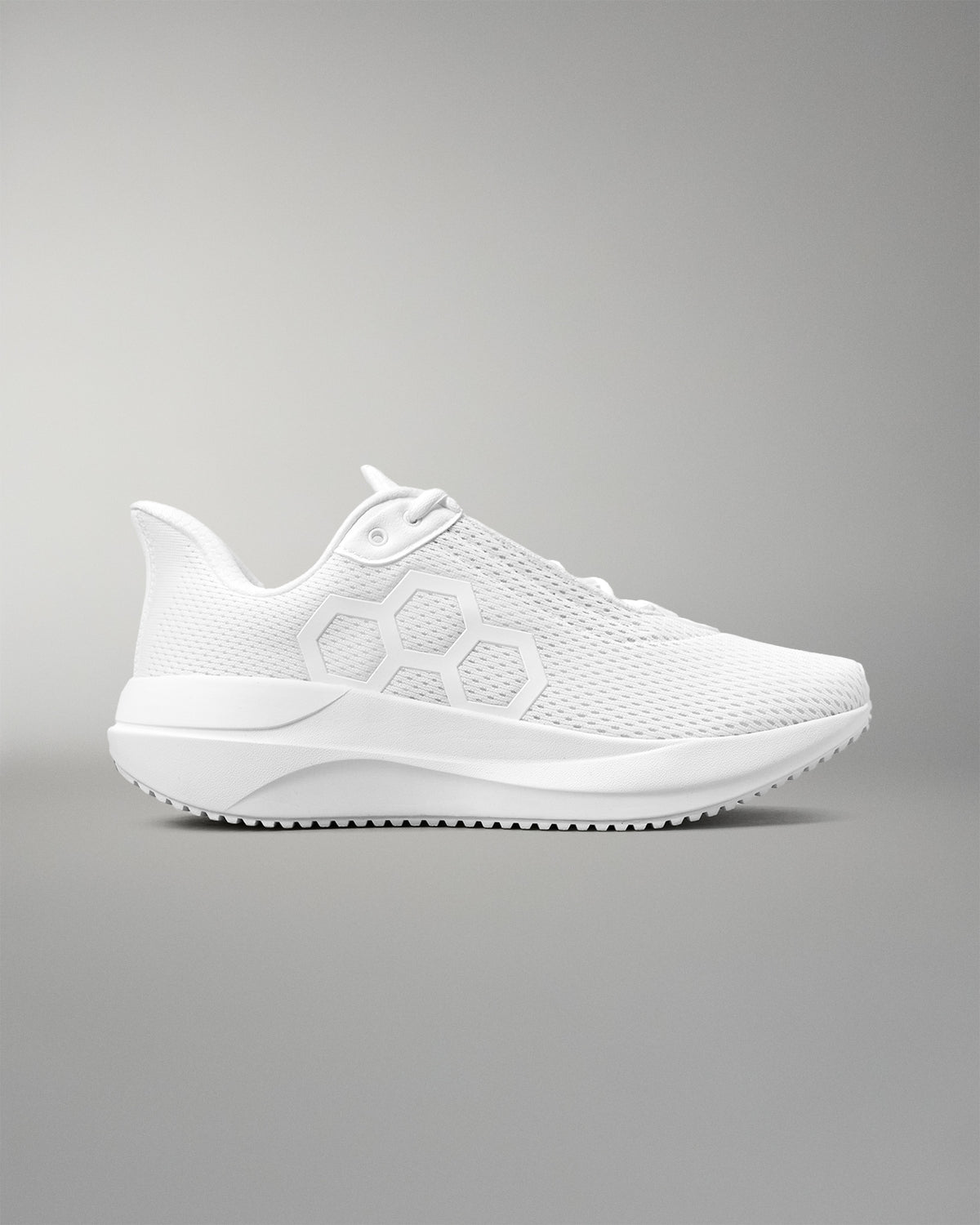 White athletic shoe on a gray background