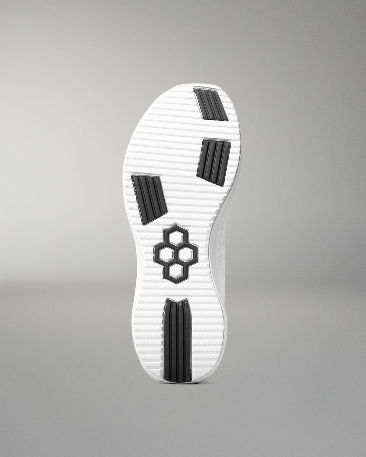 White shoe sole with black patterns on a gray background
