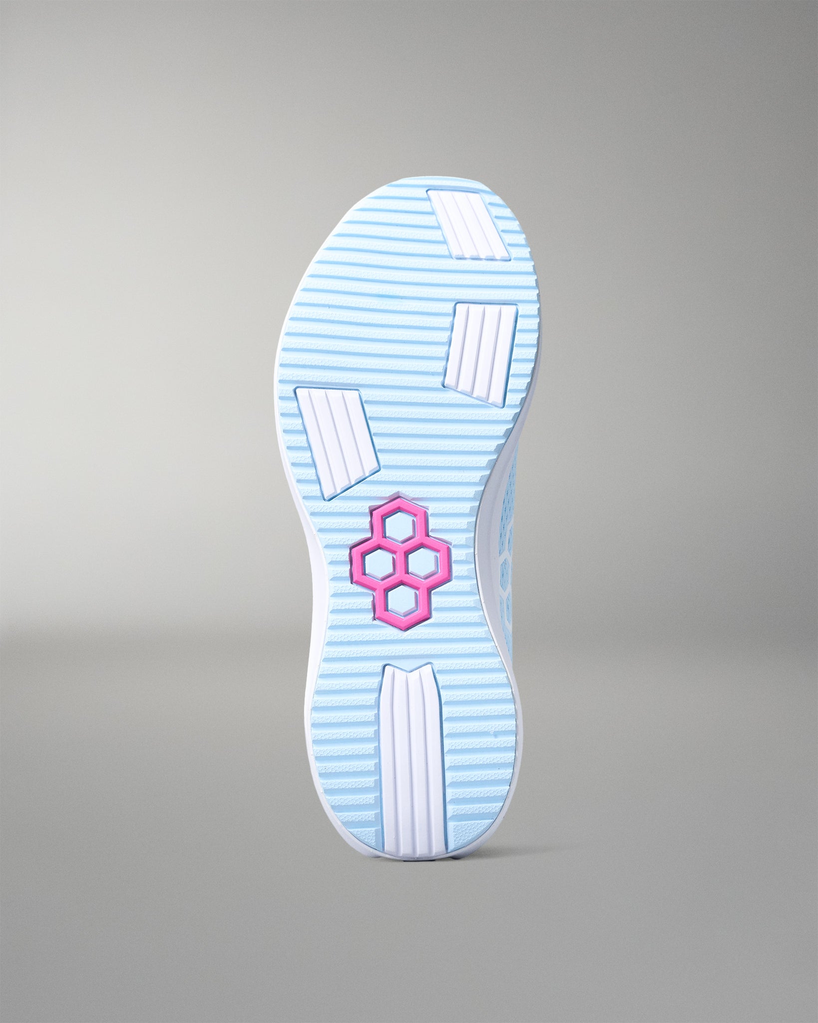 Sole of a shoe with a pink logo on a gray background