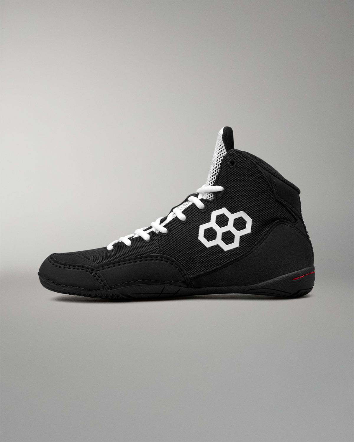 Black wrestling shoe with RUDIS branding on a light gray background