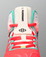 Close-up of the RUDIS Hildebrandt 2.0 Women’s Wrestling Shoe tongue with Hildebrandt branding, RUDIS logo, coral laces, and teal supports.