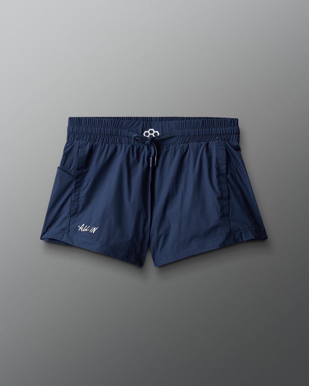 Navy blue shorts with a brand logo on a gray background