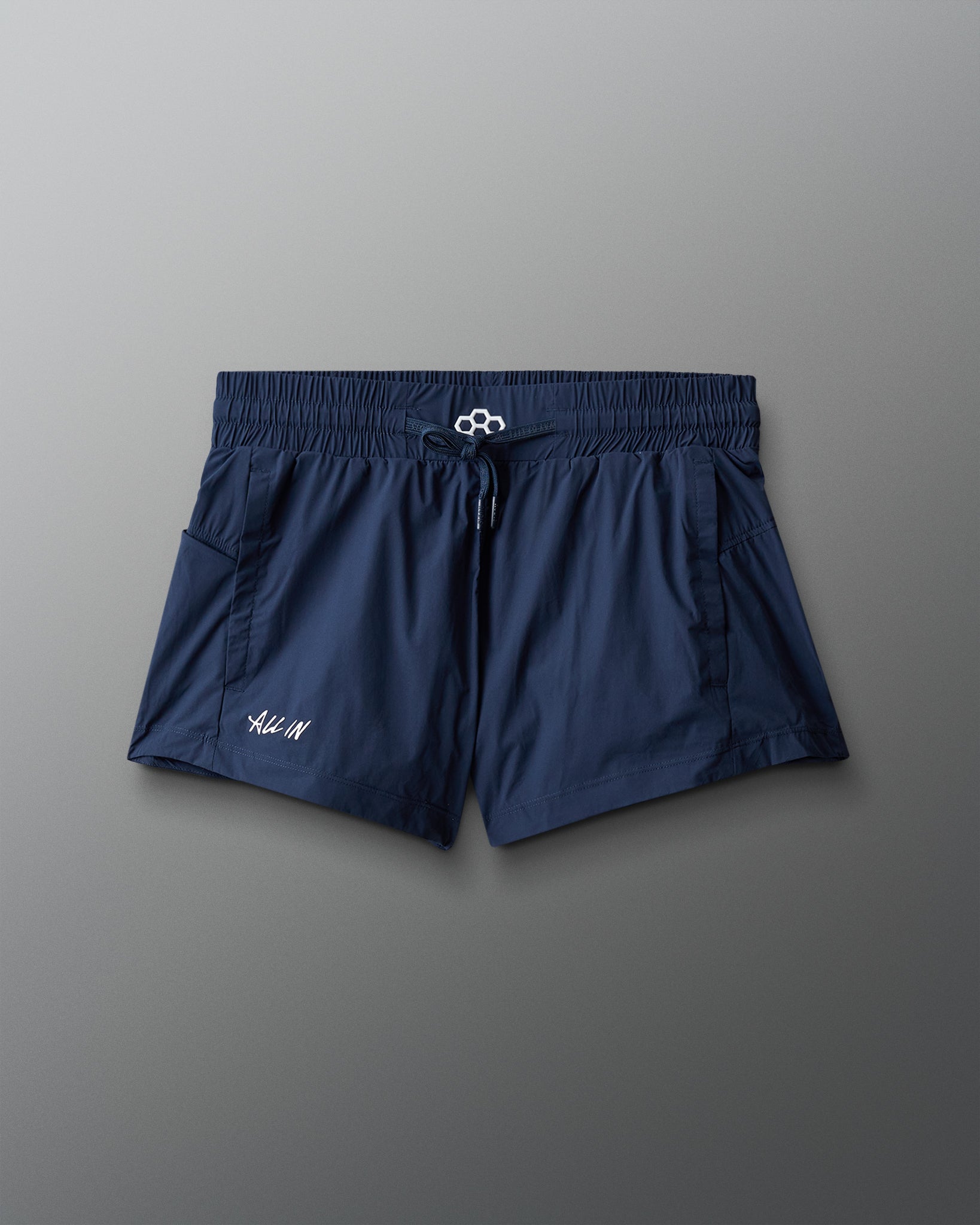 Navy blue shorts with a brand logo on a gray background