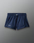 Navy blue shorts with a brand logo on a gray background