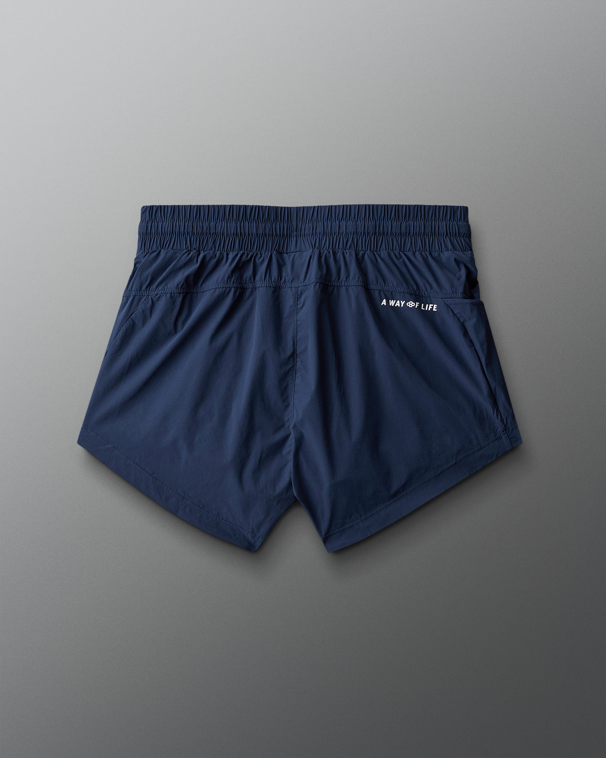 Navy blue shorts with a brand logo on a gray background