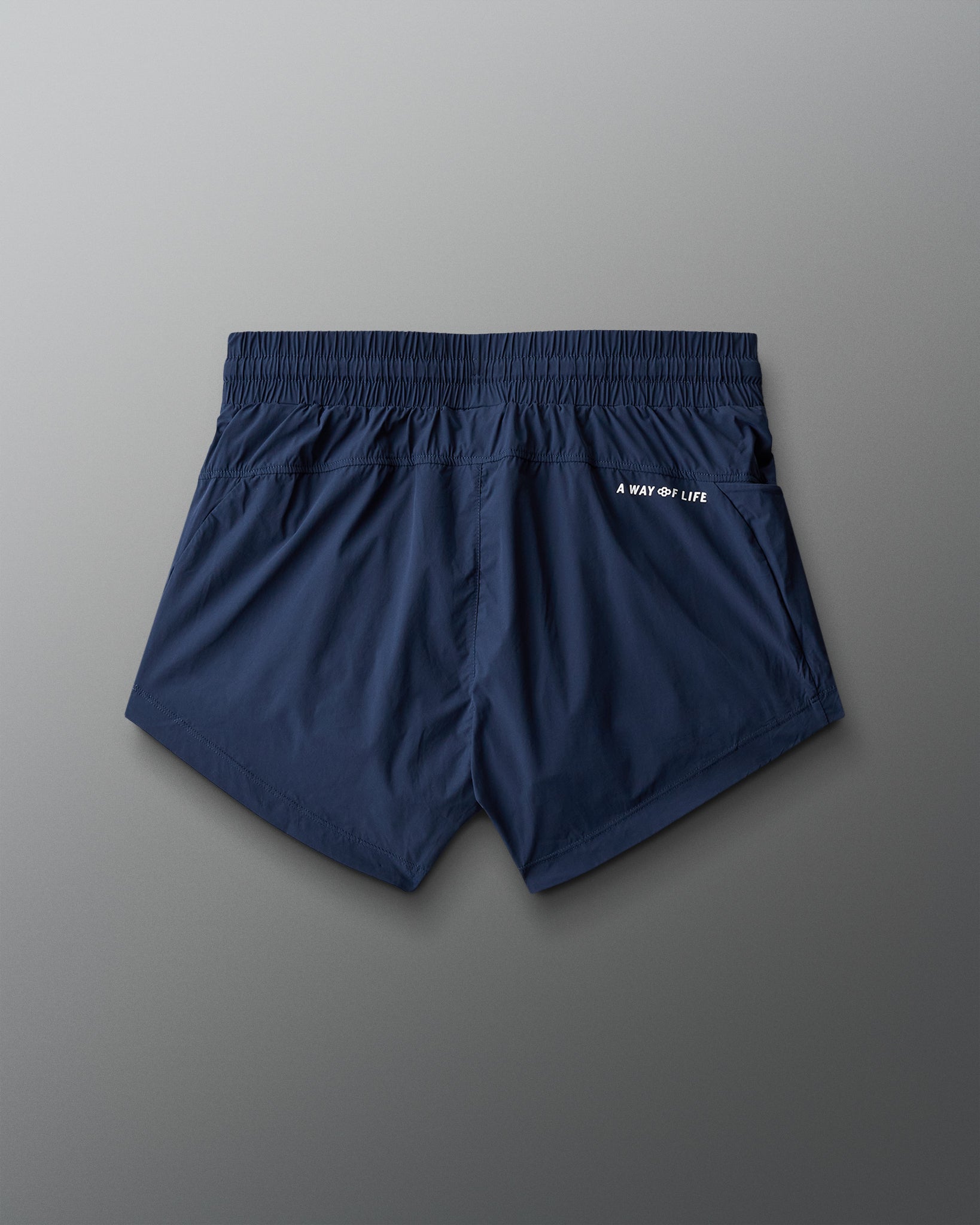 Navy blue shorts with a brand logo on a gray background