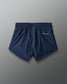 Navy blue shorts with a brand logo on a gray background