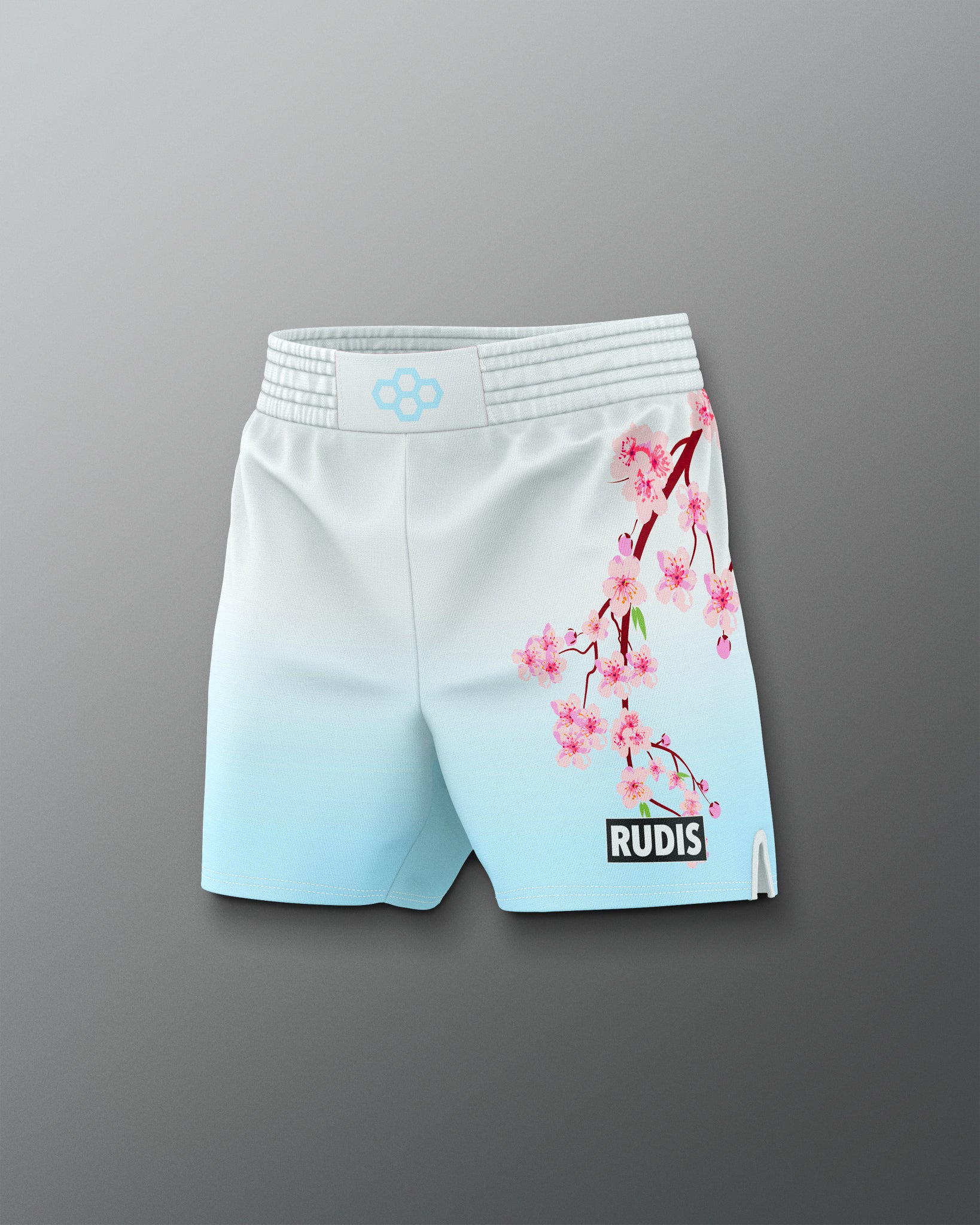 Light blue and white shorts with cherry blossom design on a gray background