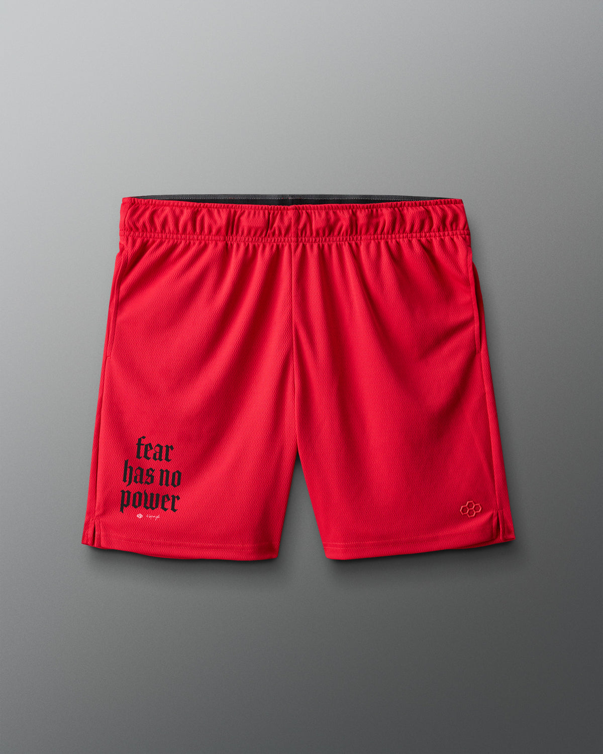 Red shorts with 'fear has no power' text on a gray background