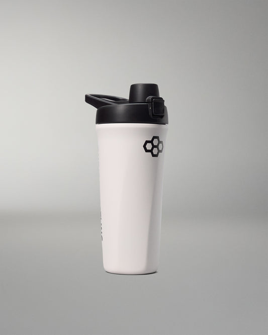 White shaker bottle with black lid on a gray background
