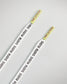 A pair of white shoelaces featuring yellow tips prominently displaying the brand name RUDIS along their length