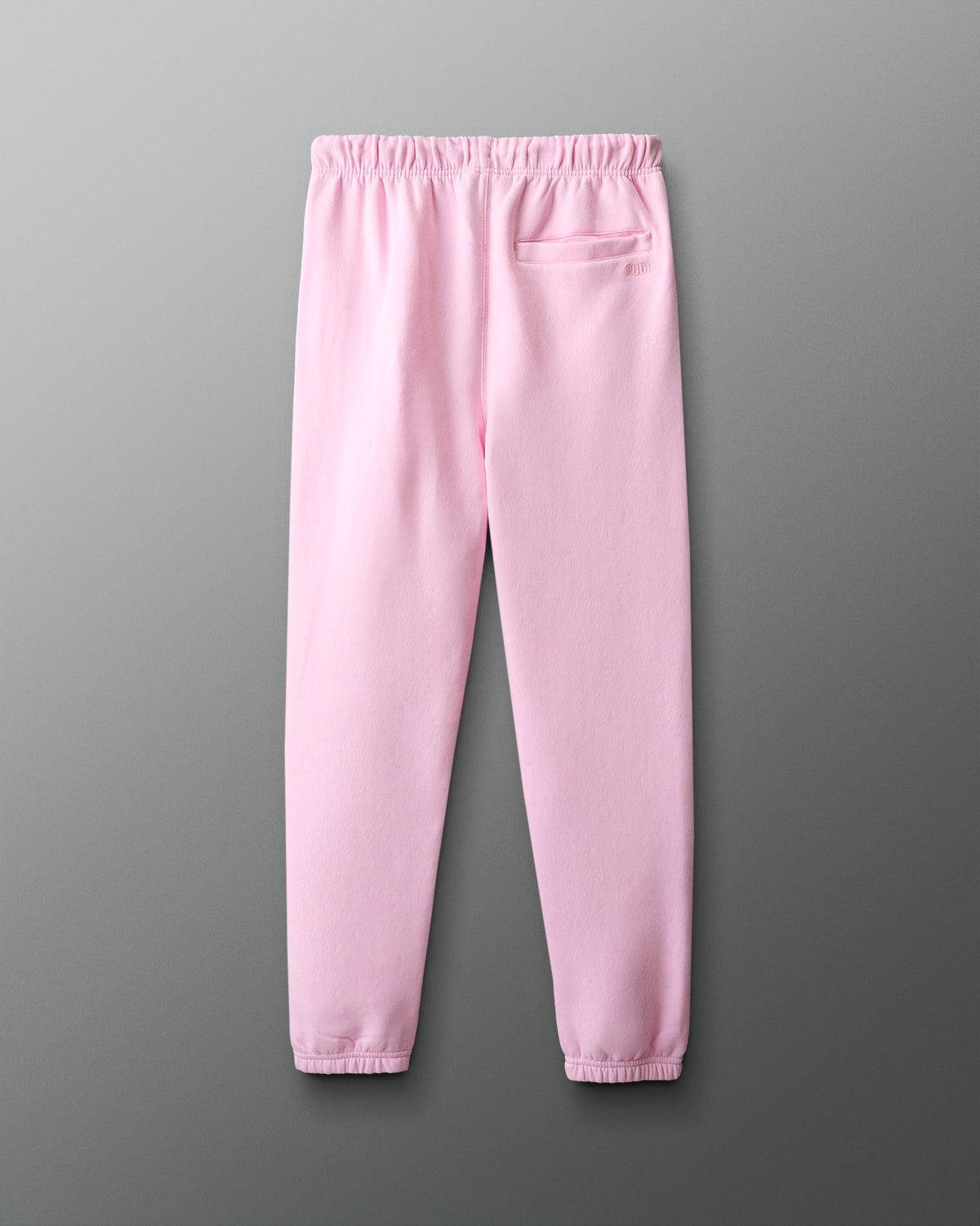 Pink sweatpants on a gray background
