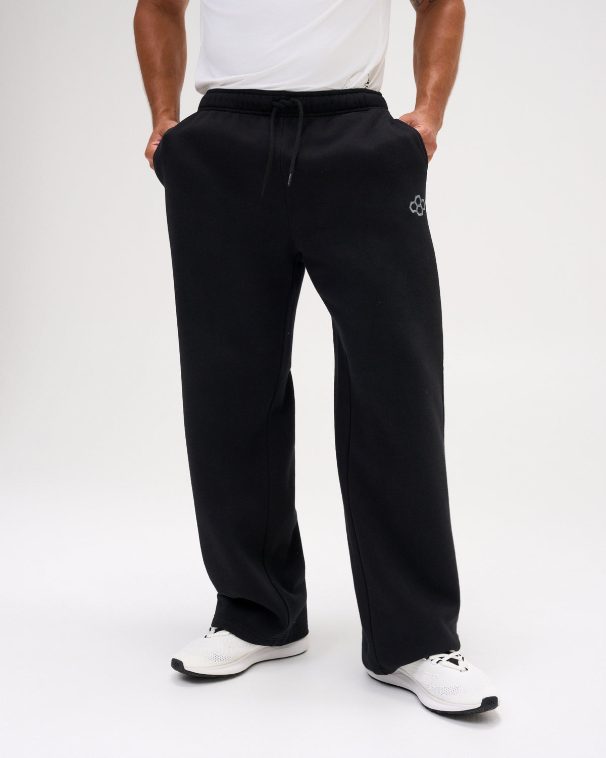 Front view of men's RUDIS Comfort Fleece Wide Leg Sweatpants in Black, highlighting the wide-leg cut, elastic drawstring waistband, side pockets and RUDIS logo. Copy Alt Text