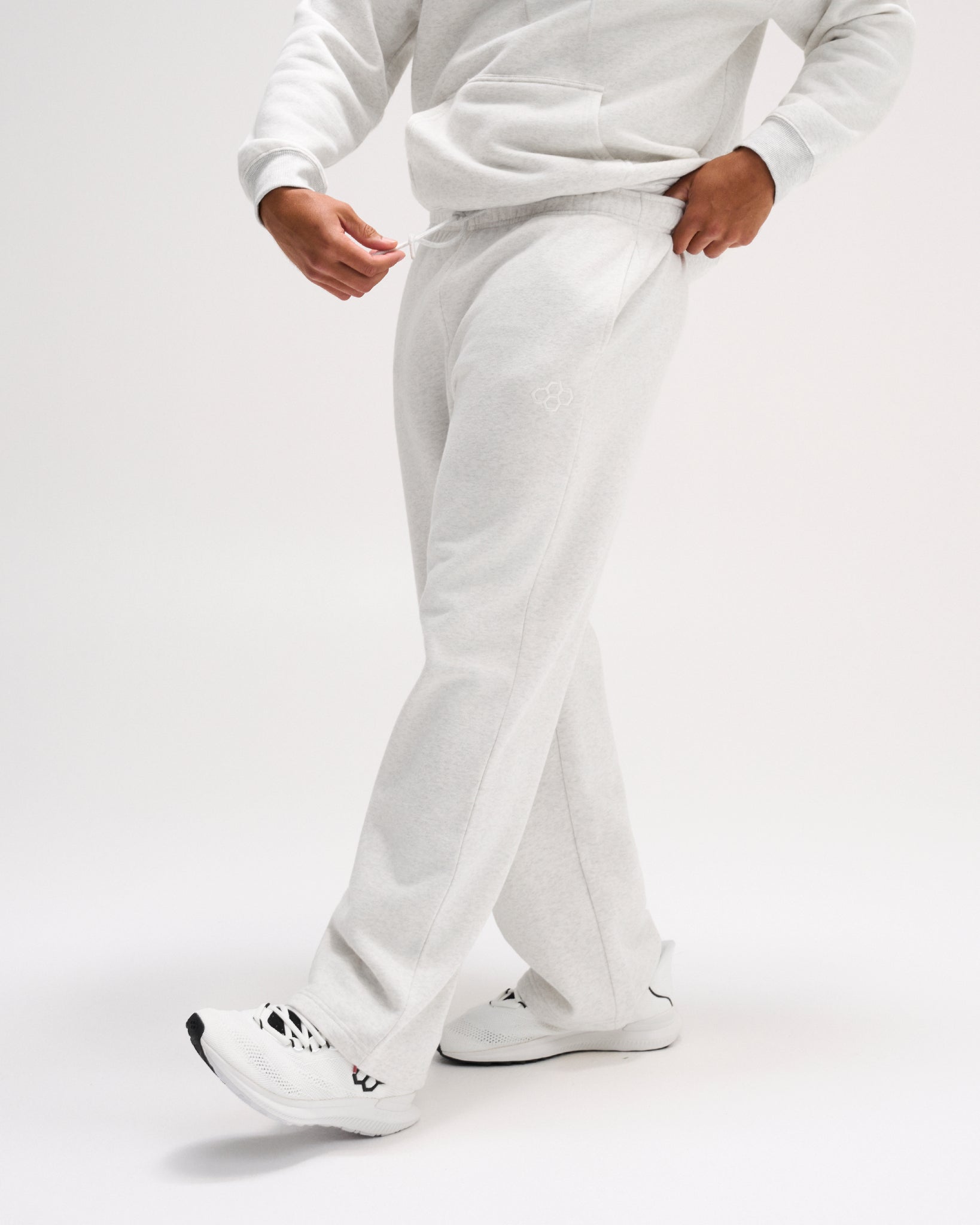 Side view of RUDIS Comfort Fleece Wide Leg Sweatpants in Heather Silver, featuring a relaxed straight silhouette, drawstring waistband and subtle RUDIS logo. Copy Alt Text