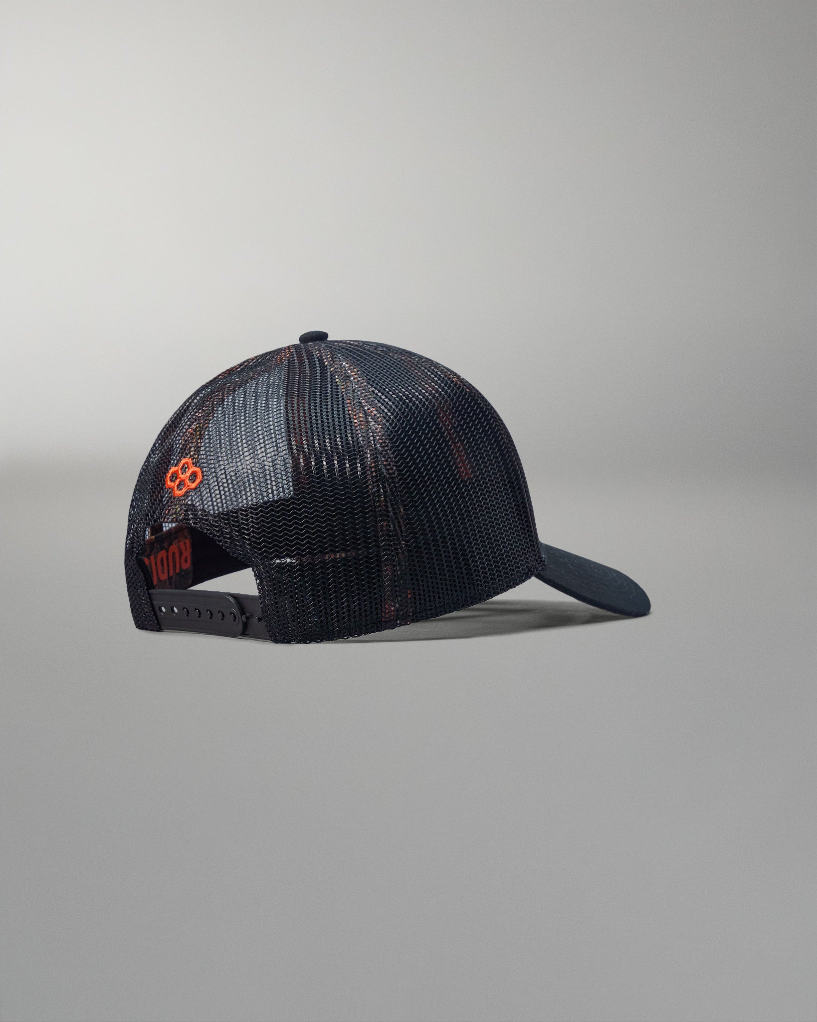 Black mesh cap with orange logo on a gray background