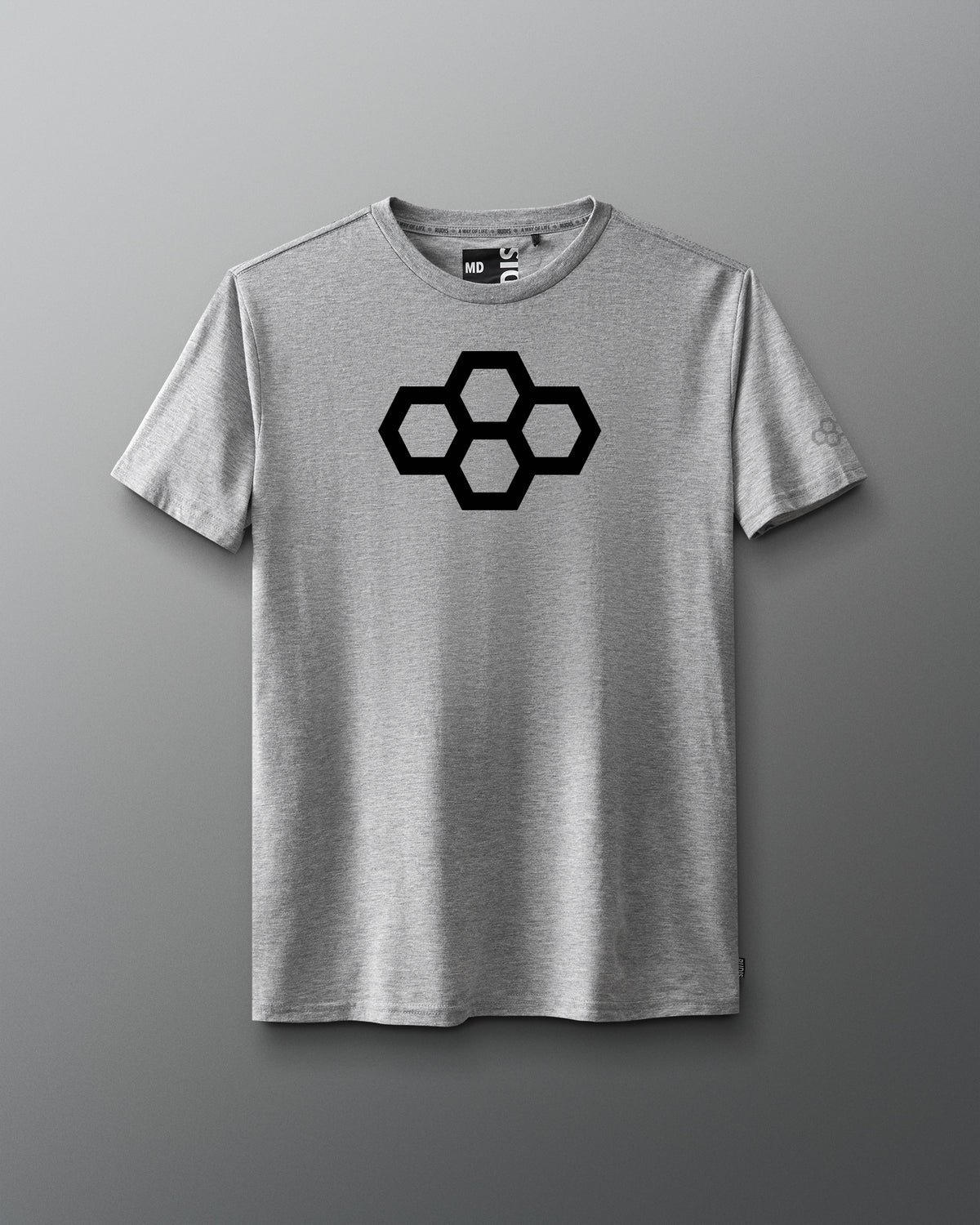 A gray t-shirt with a white quadhex graphic design on the front and a smaller hexagonal logo on the left sleeve.