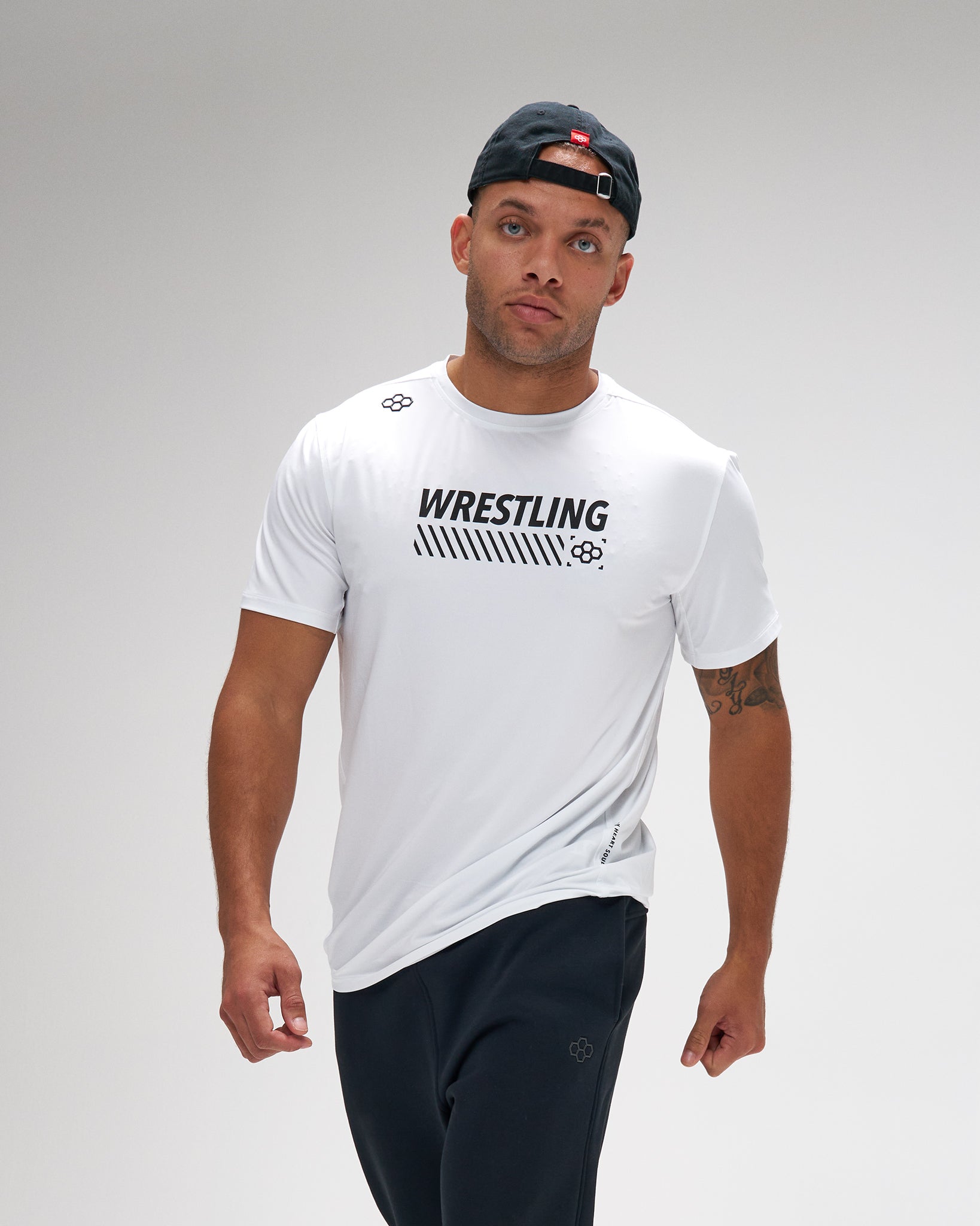 Man wearing a white 'Wrestling' t-shirt on a gray background