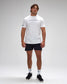 Man wearing a white 'Wrestling' t-shirt and black shorts on a gray background