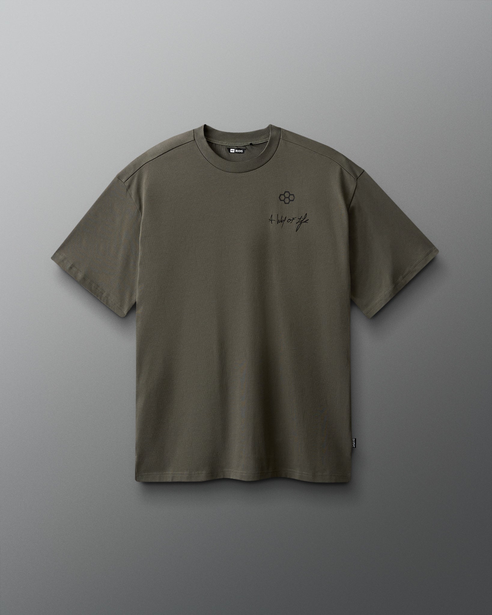Green t-shirt with a small logo on a gray background