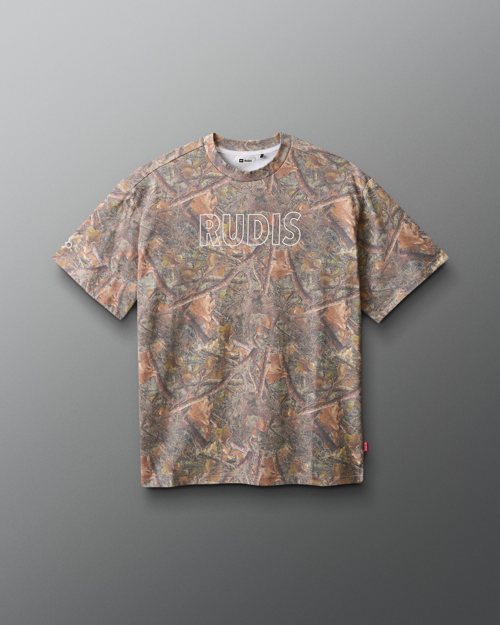 Camouflage-patterned t-shirt with 'RUDIS' branding on a gray background