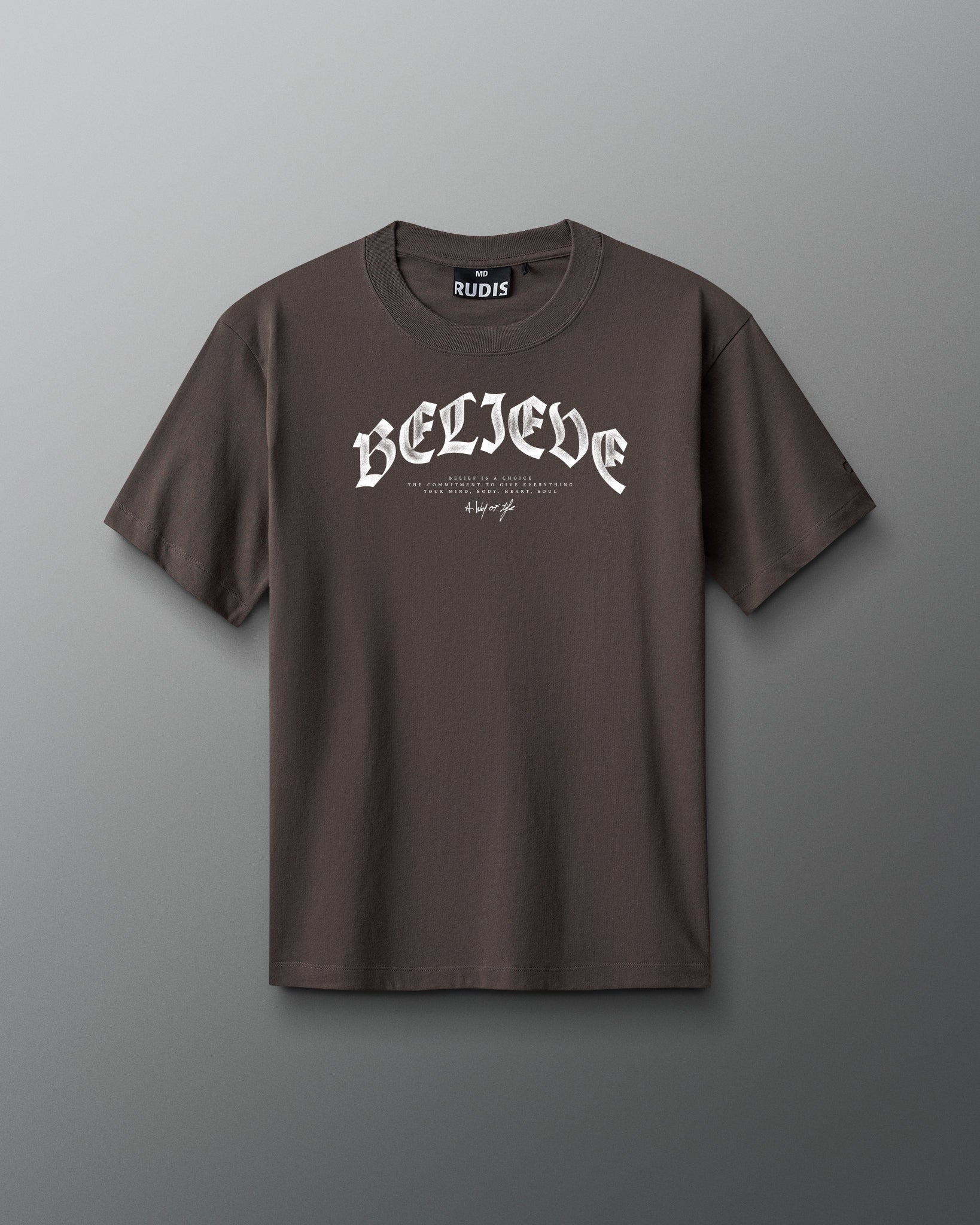 Brown t-shirt with 'BELIEVE' text on a gray background