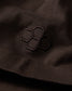 Close-up of a black embroidered design on a dark fabric surface