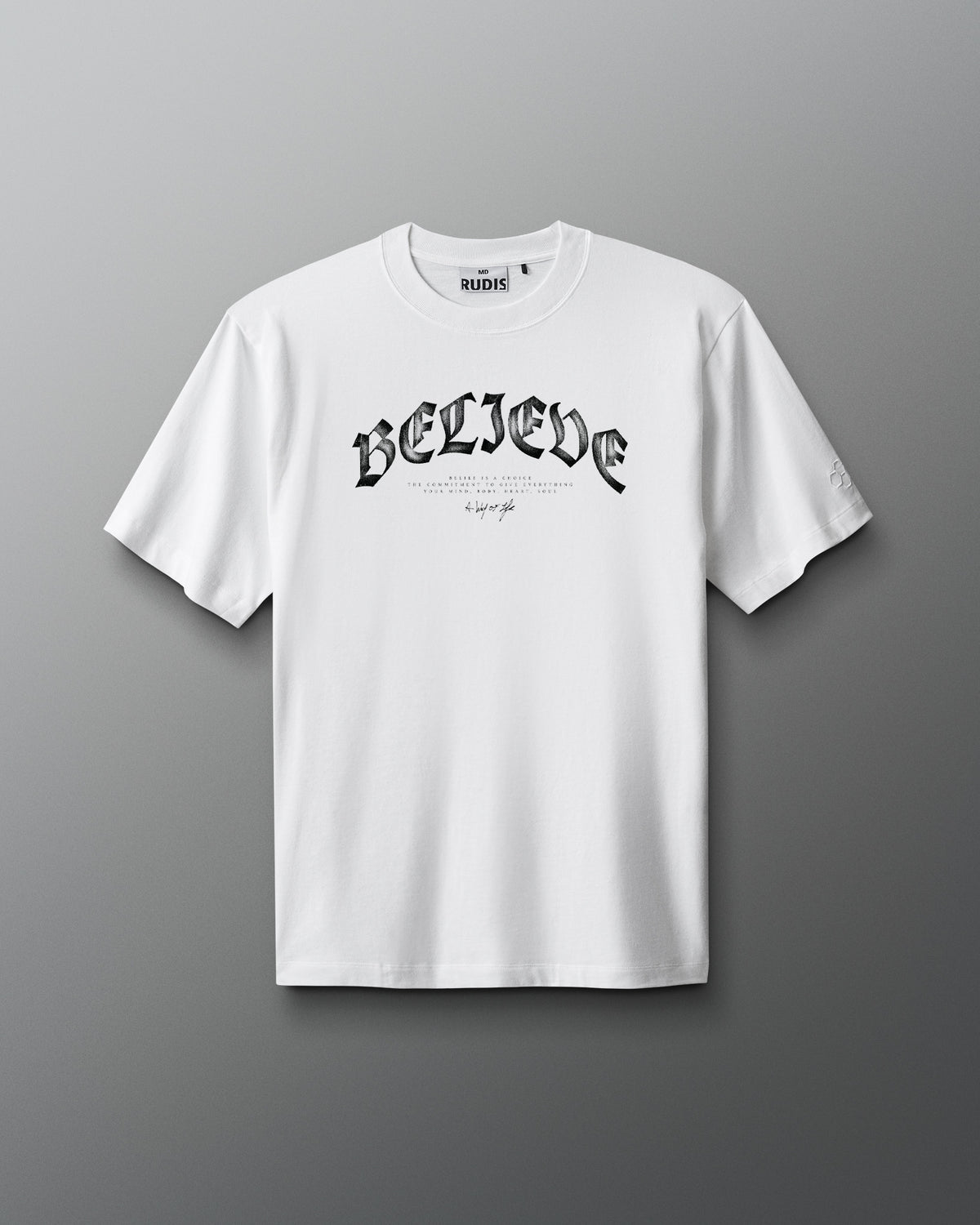 White t-shirt with 'BELIEVE' text on a gray background