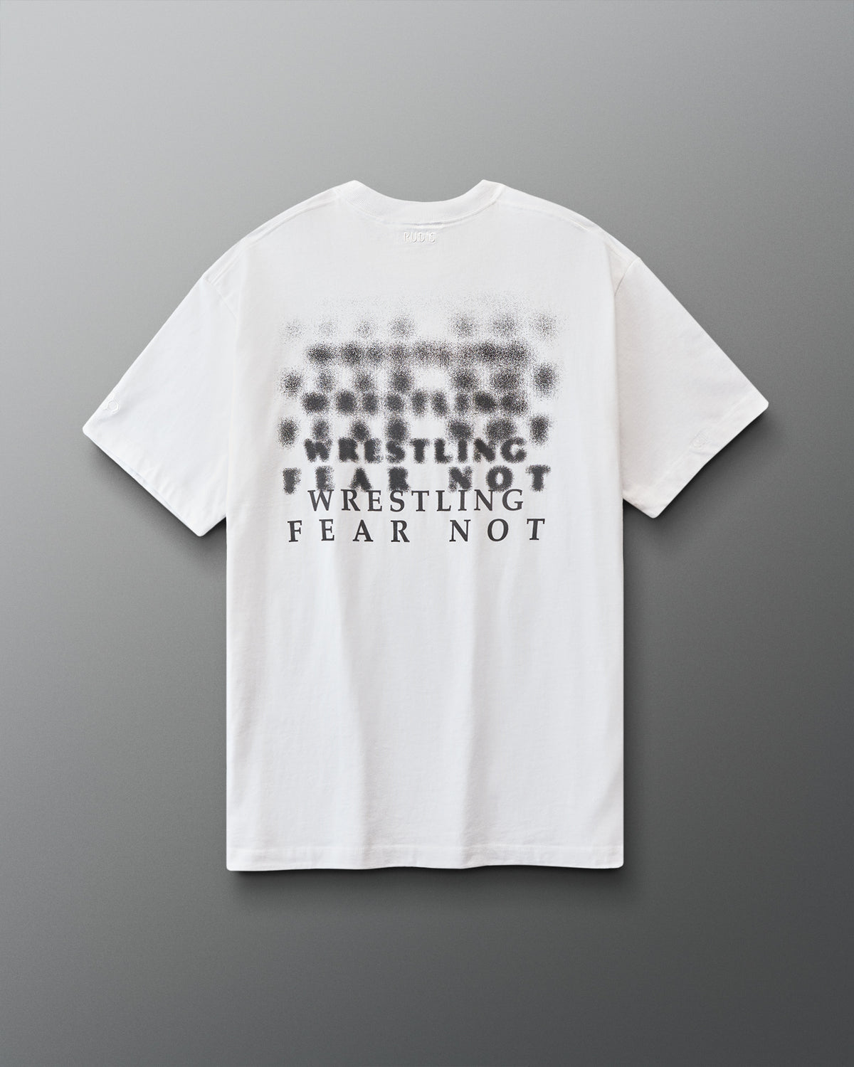 White t-shirt with black 'Wrestling fear not' text on a gray background