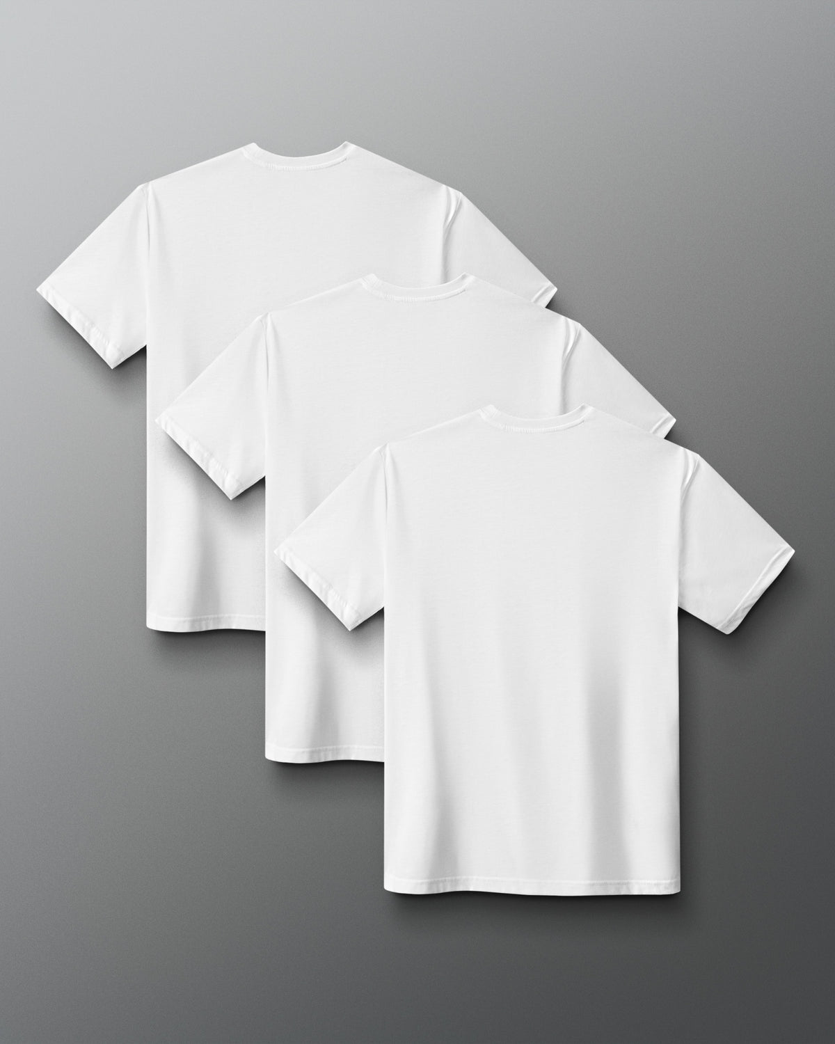 Three White short-sleeve crewneck t-shirts arranged in a cascading stack on a dark gray gradient background.