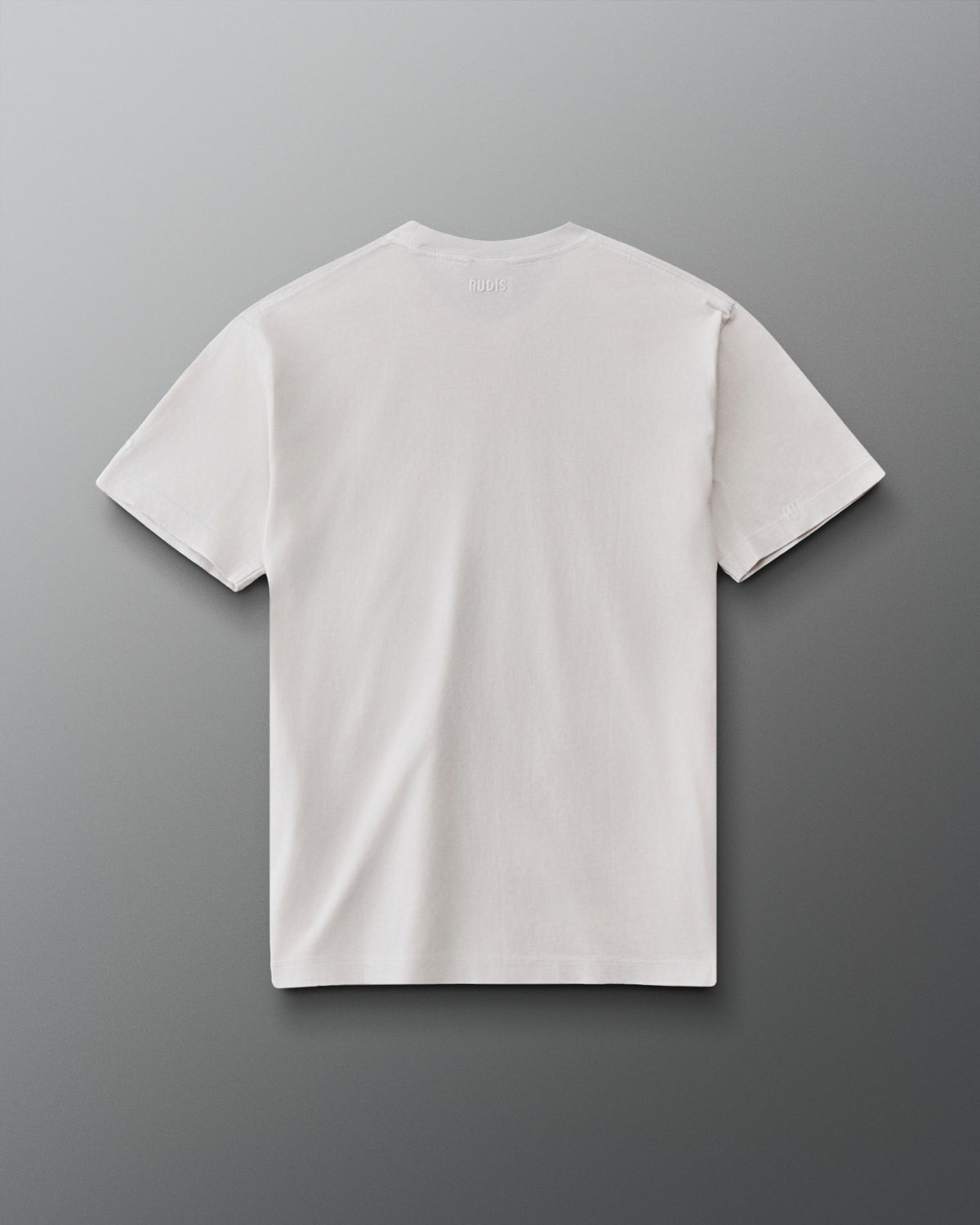 RUDIS Tilted Hex Classic Cotton T-Shirt in Washed Lunar, back view showing a clean off-white design with subtle RUDIS branding below the collar.