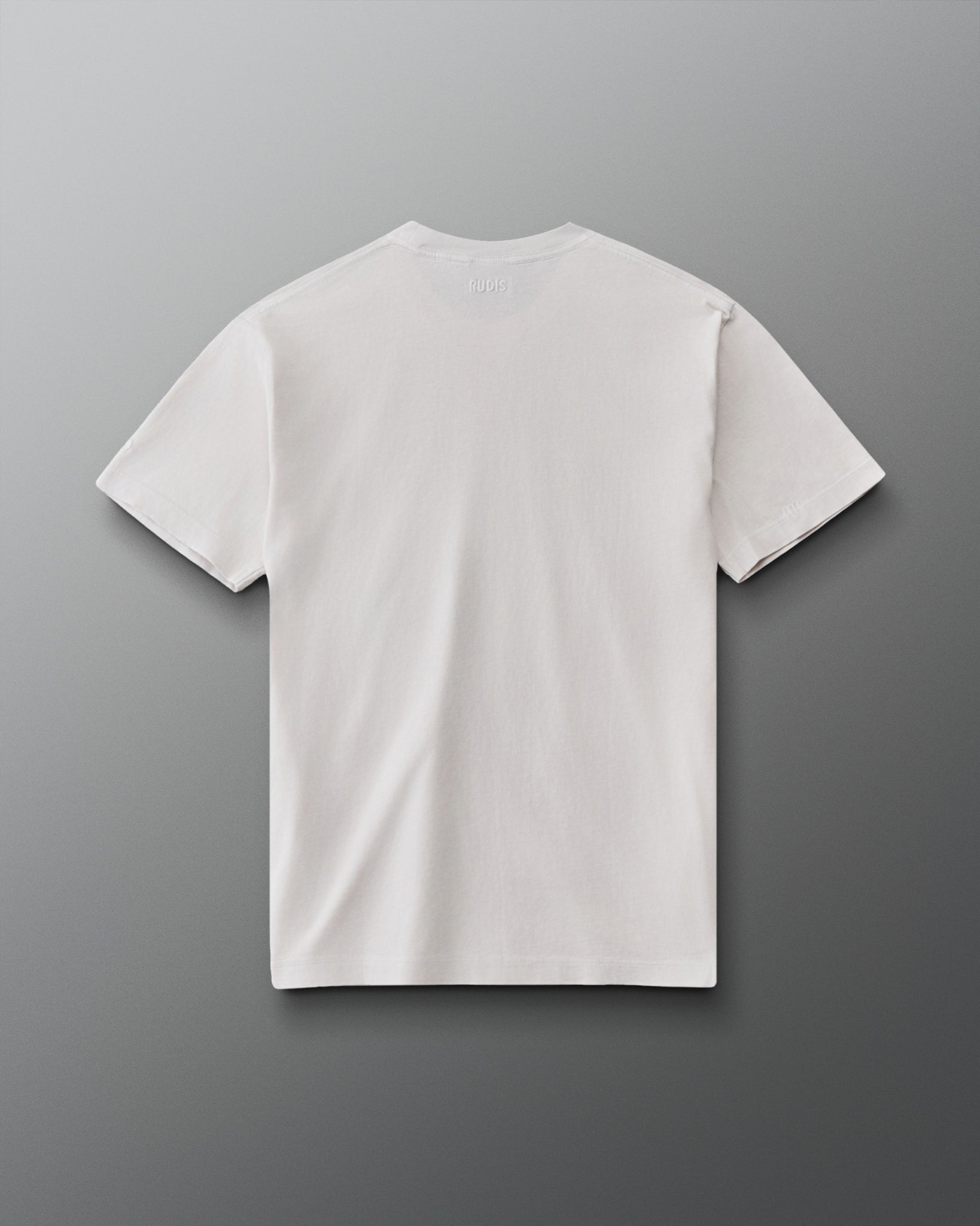 RUDIS Tilted Hex Classic Cotton T-Shirt in Washed Lunar, back view showing a clean off-white design with subtle RUDIS branding below the collar.
