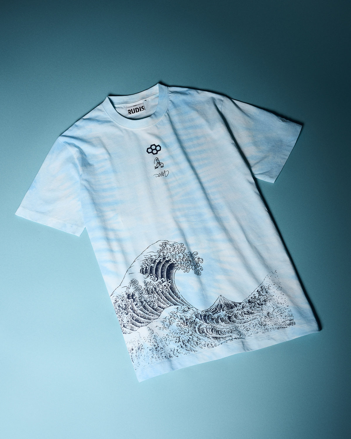 RUDIS Samurai Ikigai Classic Cotton T-Shirt in blue tie-dye, laid flat with Japanese-inspired wave artwork, subtle chest graphics, and RUDIS branding.