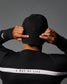 Person wearing a black cap and black jacket with 'A Way of Life' text on a gray background