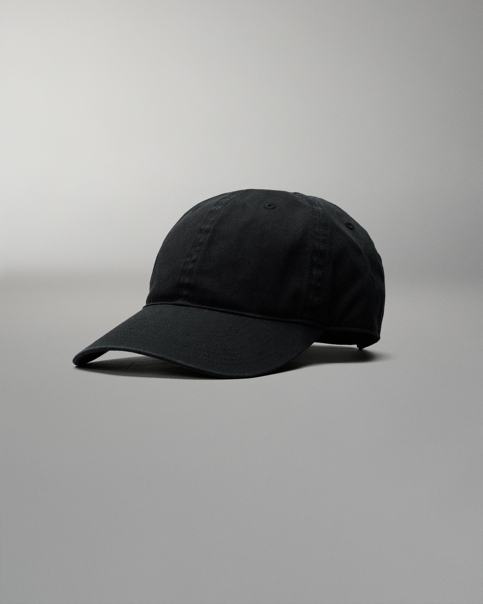 Black baseball cap on a gray background