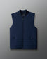 Navy blue puffer vest with a round neckline and zippered front.