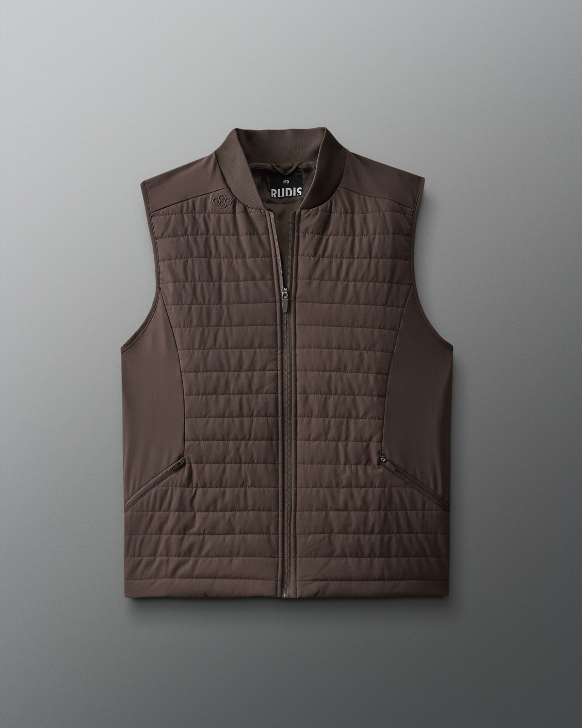 A brown puffer vest with a ribbed collar, two front zip pockets, and a visible brand logo on the chest.