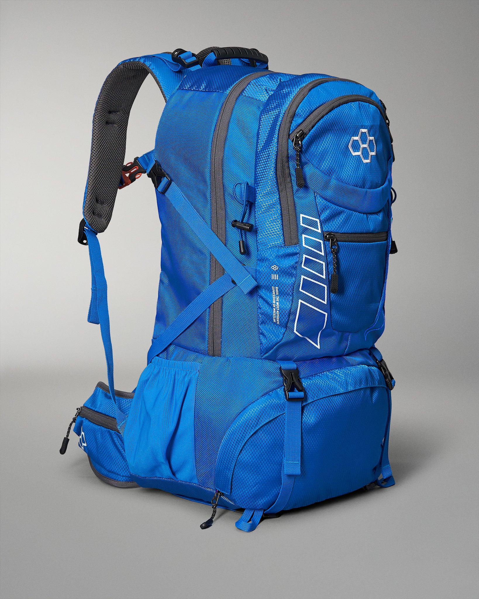 Blue backpack with gray straps on a gray background