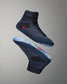 High-top wrestling shoes in a blue-black design with a textured upper and translucent sole, designed for performance, are presented against a smooth gradient background.