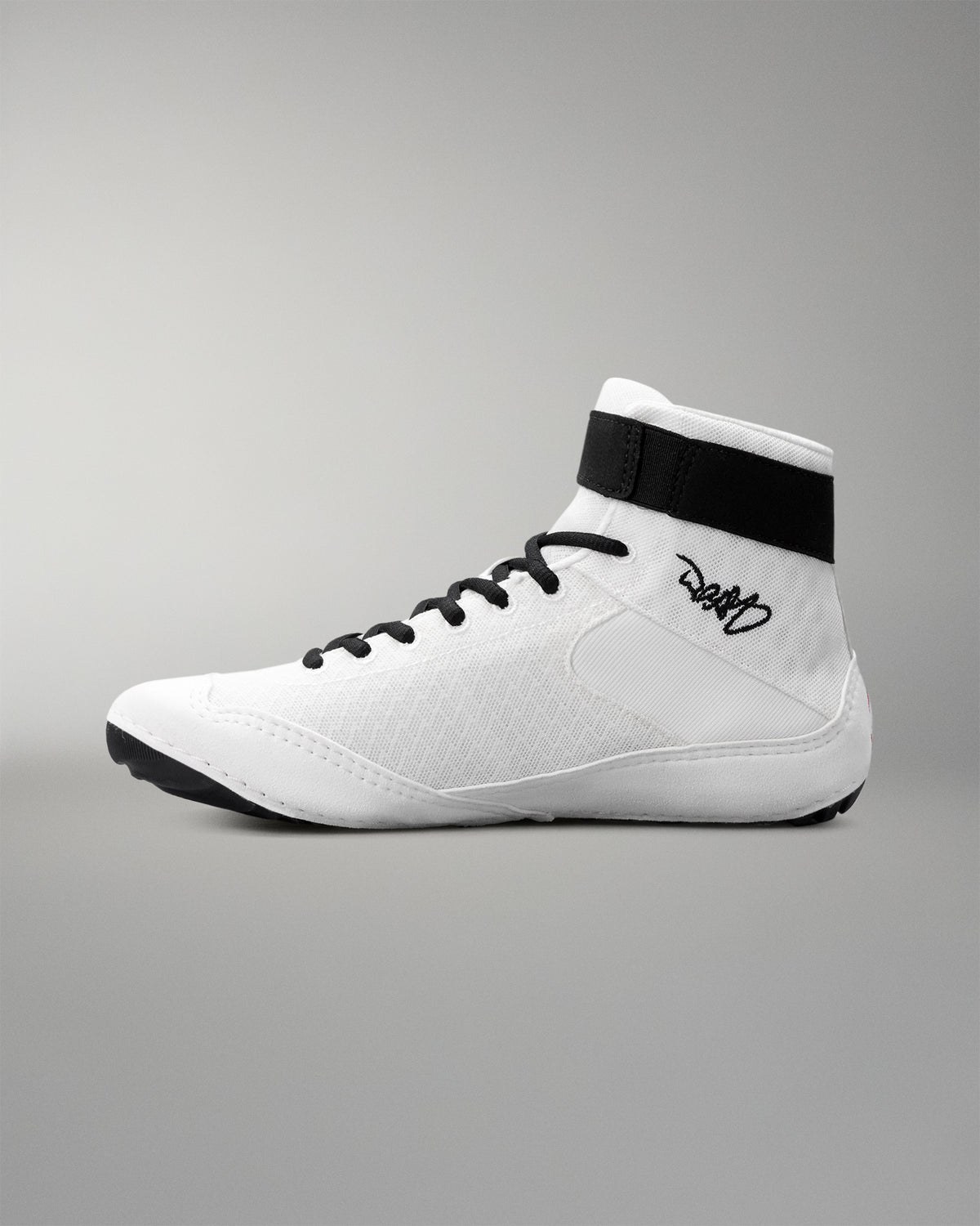 White wrestling shoe with black accents on a gray background
