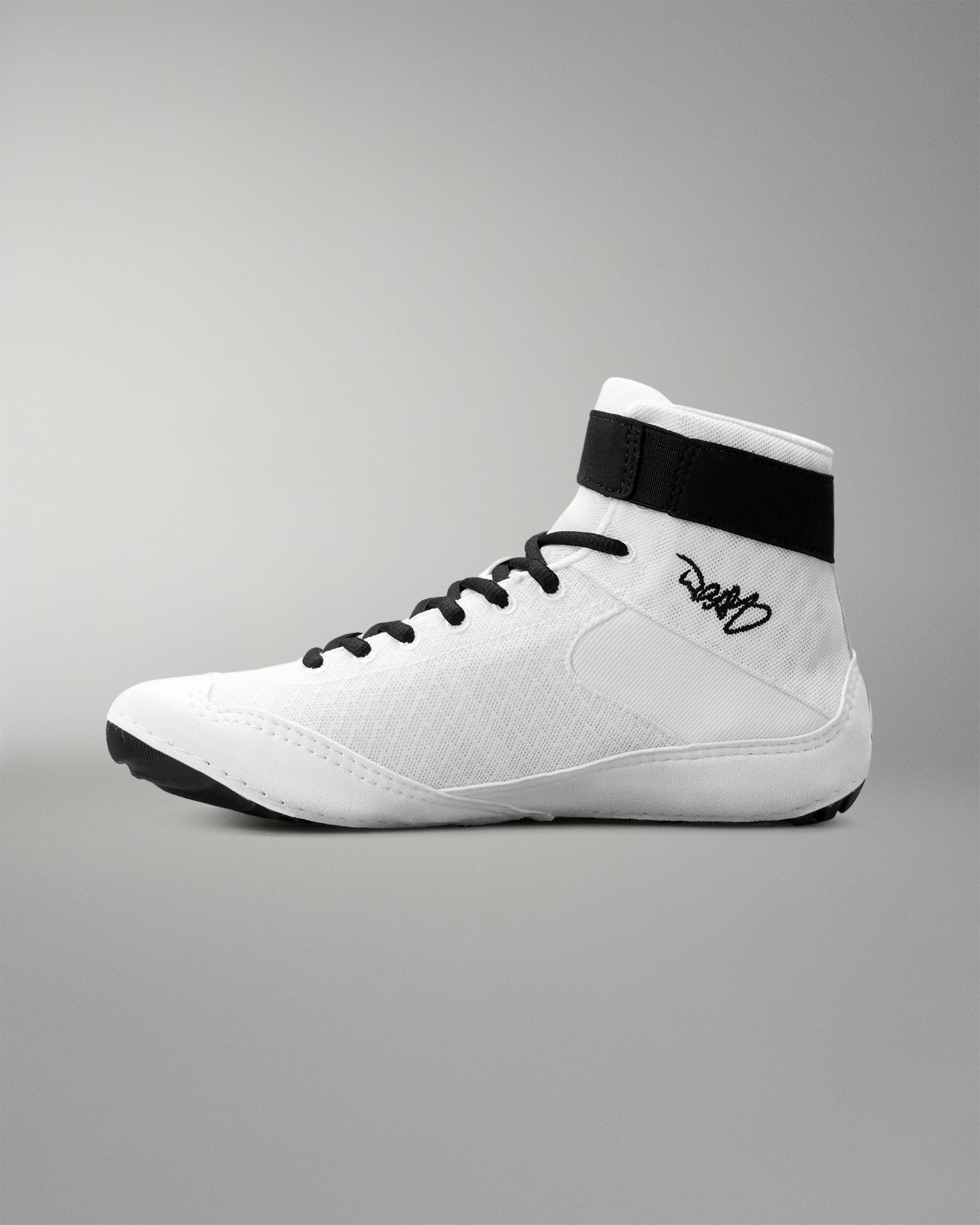White wrestling shoe with black accents on a gray background