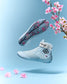 Light blue wrestling shoes with floral design on a light blue background with pink flowers.