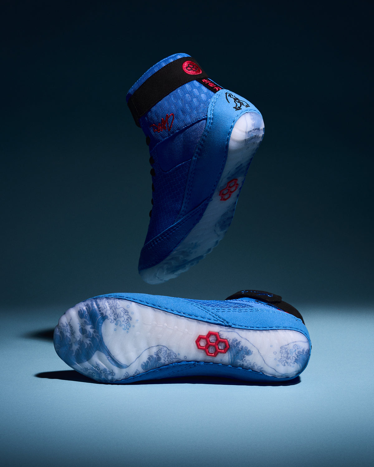 RUDIS Samurai Speed Ikigai wrestling shoes in vibrant blue, showcasing wave-inspired translucent soles, black ankle straps, and red RUDIS logos.