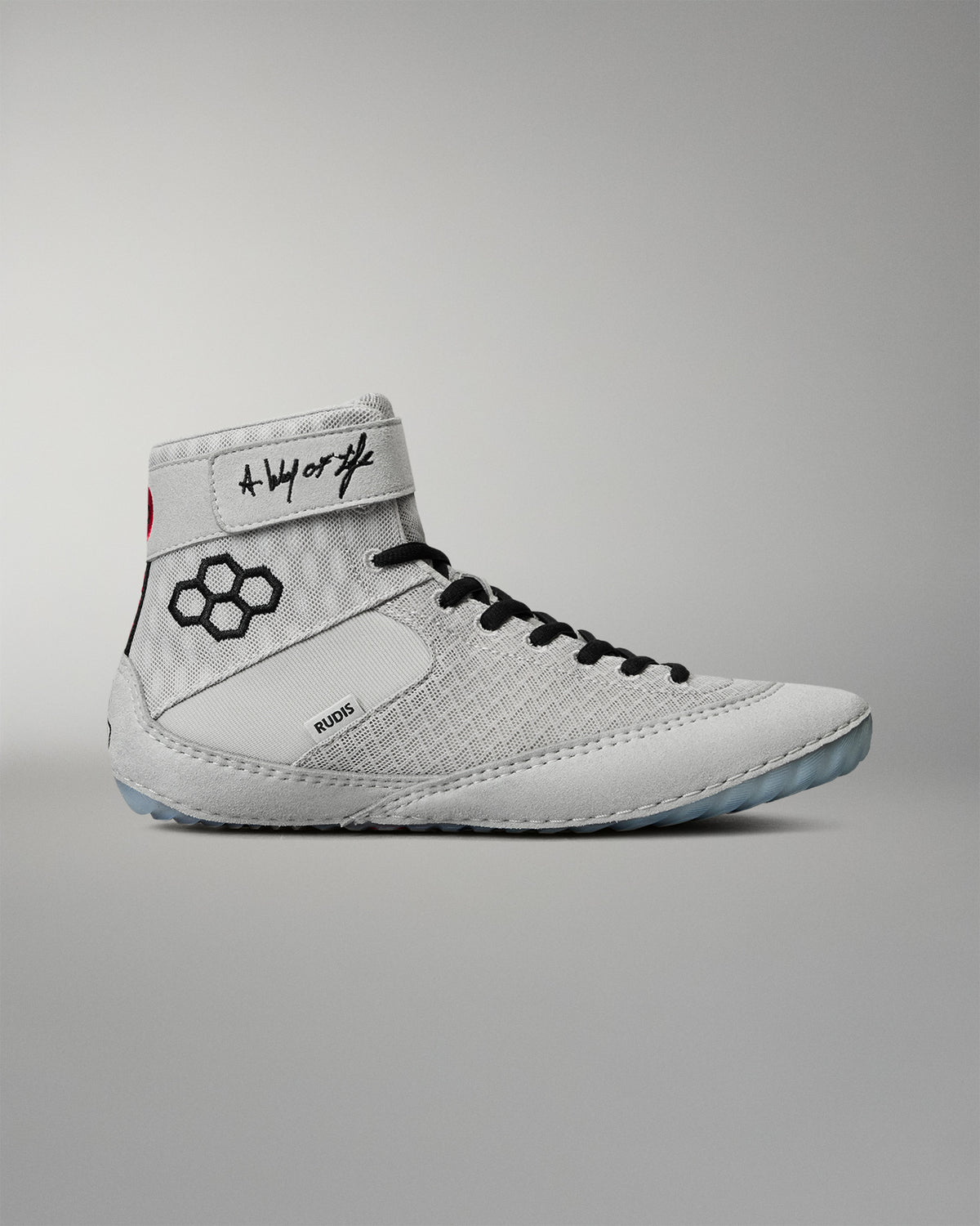 Lateral side view of the RUDIS Samurai Speed Kokoro wrestling shoe, featuring a light gray mesh upper, black RUDIS emblem, ankle strap, and translucent outsole.
