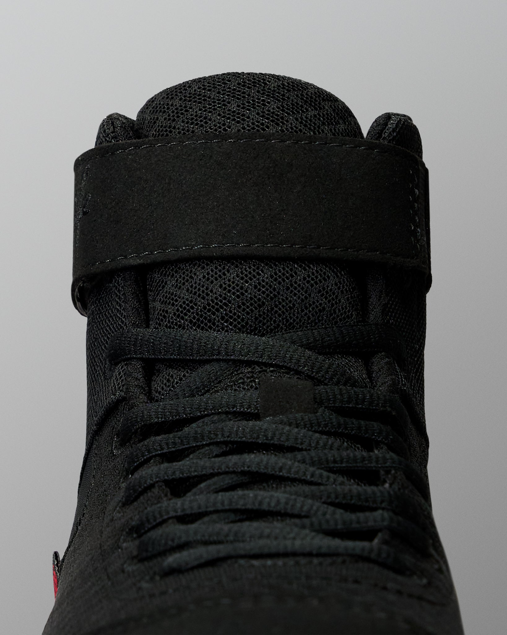 Close-up of the RUDIS Samurai Speed Wabi-Sabi wrestling shoe, highlighting black laces, textured mesh tongue, and wide ankle support strap.