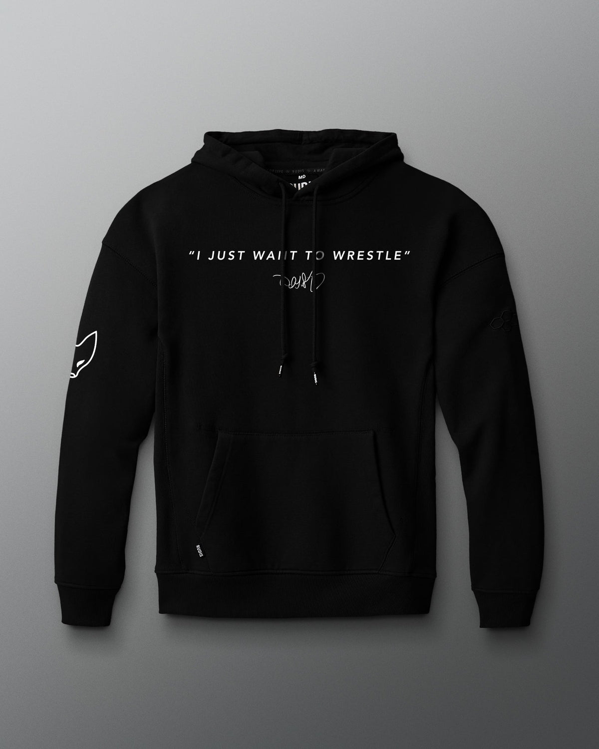 Front view of a black hoodie featuring the phrase “I JUST WANT TO WRESTLE” in white block letters across the chest, with a signature printed below. Includes a front kangaroo pocket and subtle graphics on both sleeves.