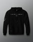 Front view of a black hoodie featuring the phrase “I JUST WANT TO WRESTLE” in white block letters across the chest, with a signature printed below. Includes a front kangaroo pocket and subtle graphics on both sleeves.