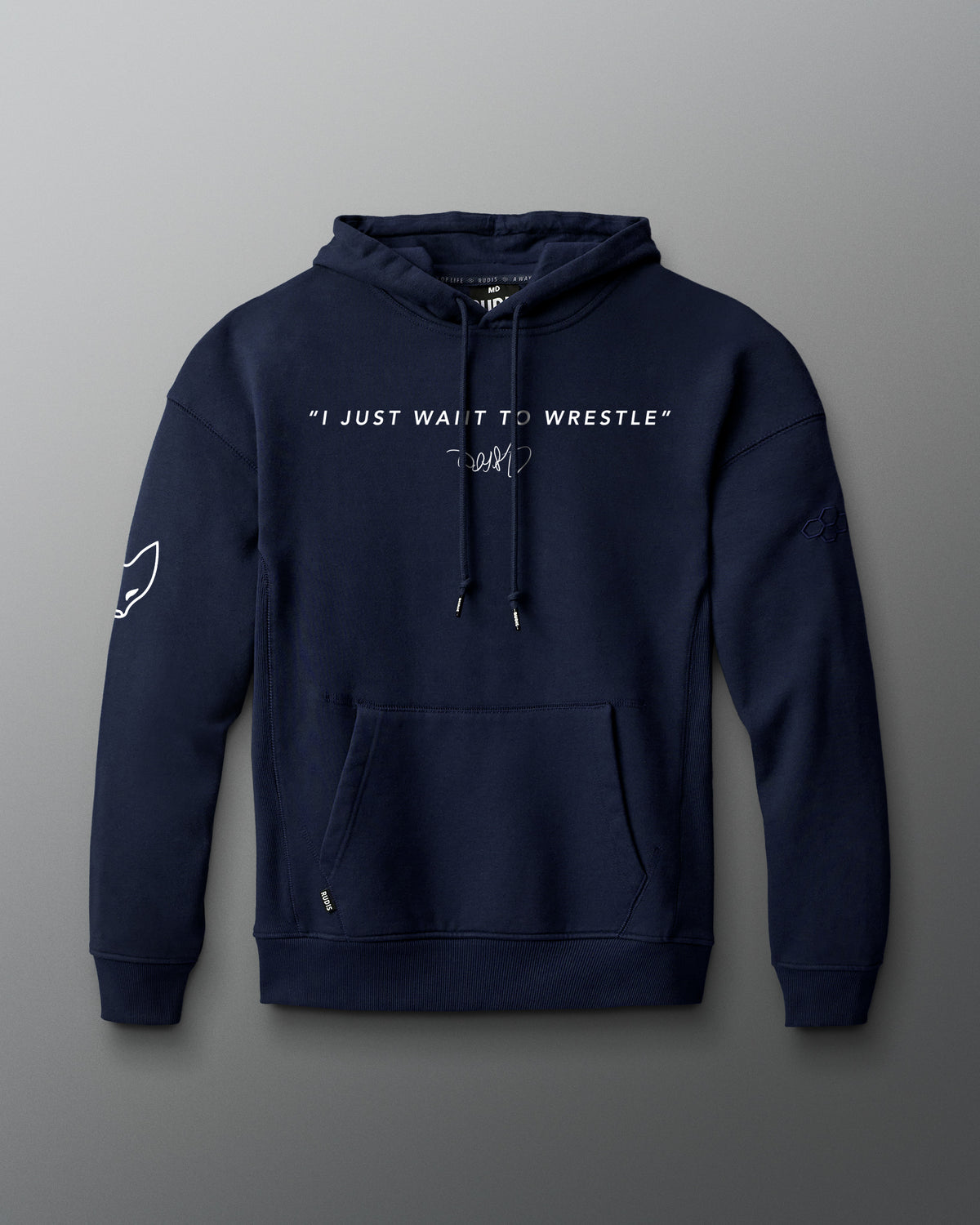 Front view of a navy hoodie featuring the phrase “I JUST WANT TO WRESTLE” in white block letters across the chest, with a signature printed below. Includes a front kangaroo pocket and subtle graphics on both sleeves.