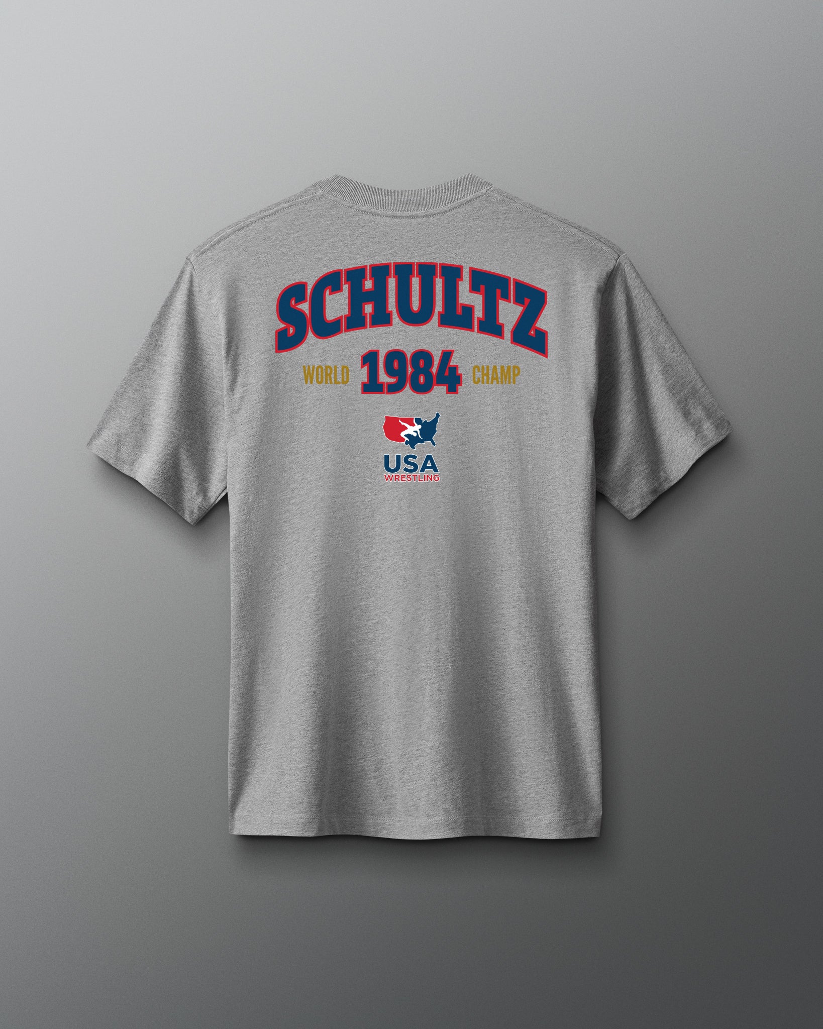 Gray t-shirt with 'Schultz 1984 World Champ USA' text on a gray background