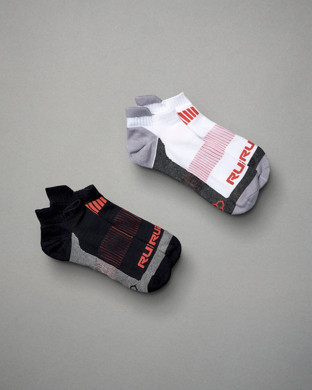 This image displays a pair of athletic socks in contrasting colors featuring modern design elements and branding